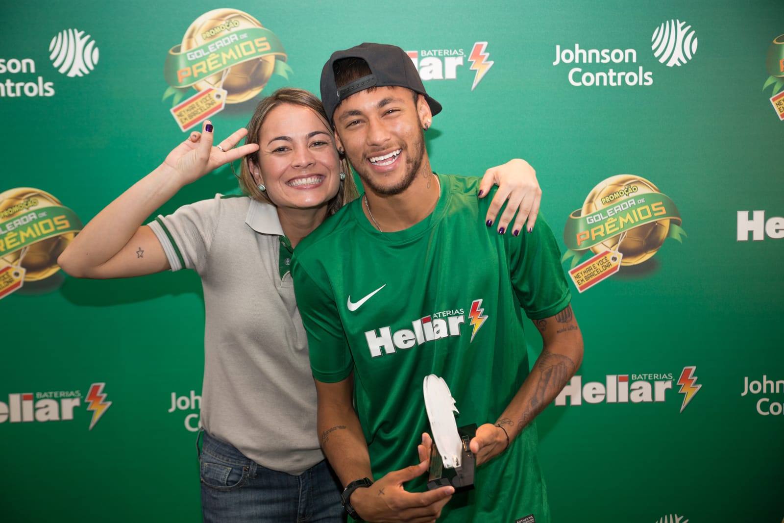 Fan next to a soccer player posing for a photo