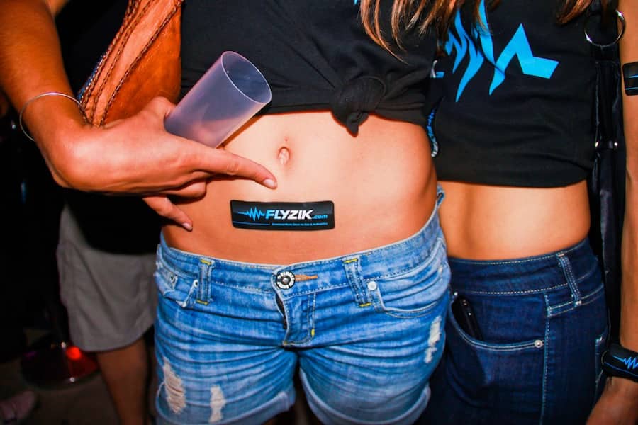 a girl is pointing on a sticker on her belly, party photo made by an event photographer based in barcelona