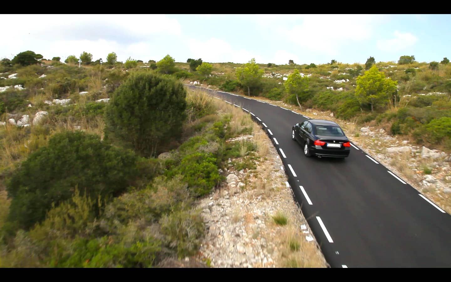 car on the road from left angle, work sample screenshot from an audiovisual company