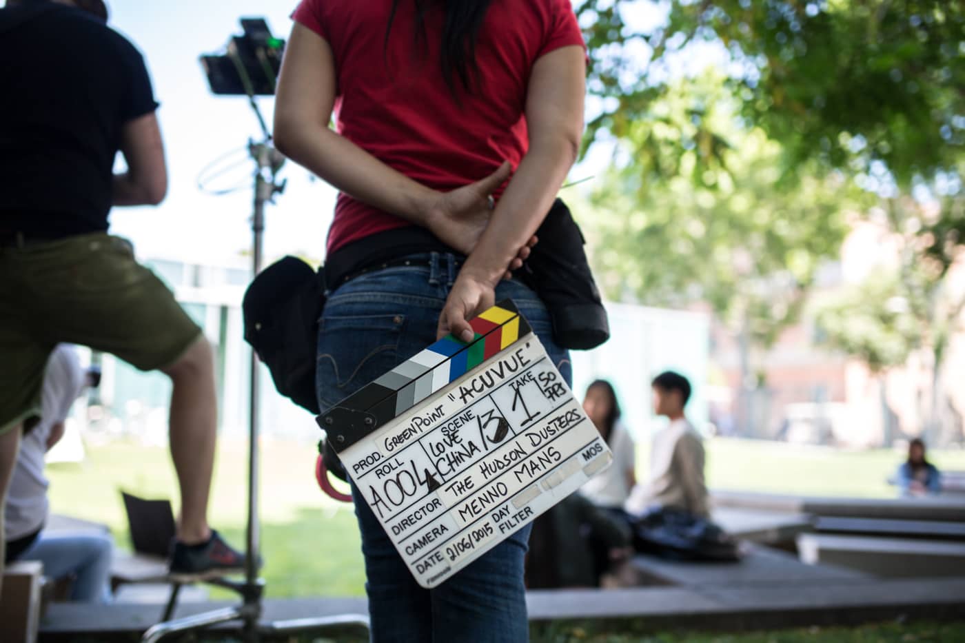 Video production staff member holding film clapper
