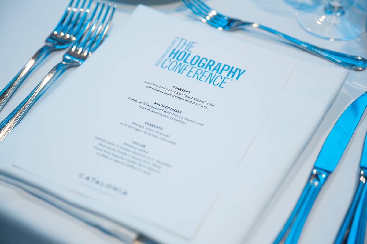 holography booklet on a table with cutlery