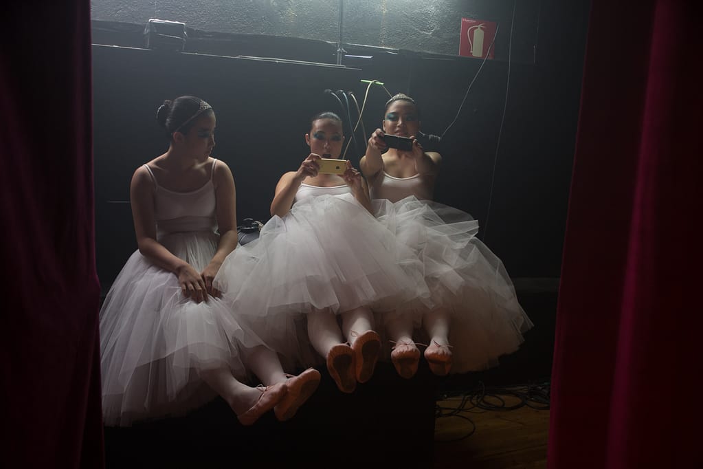 Ballerinas taking pictures of their feet backstage