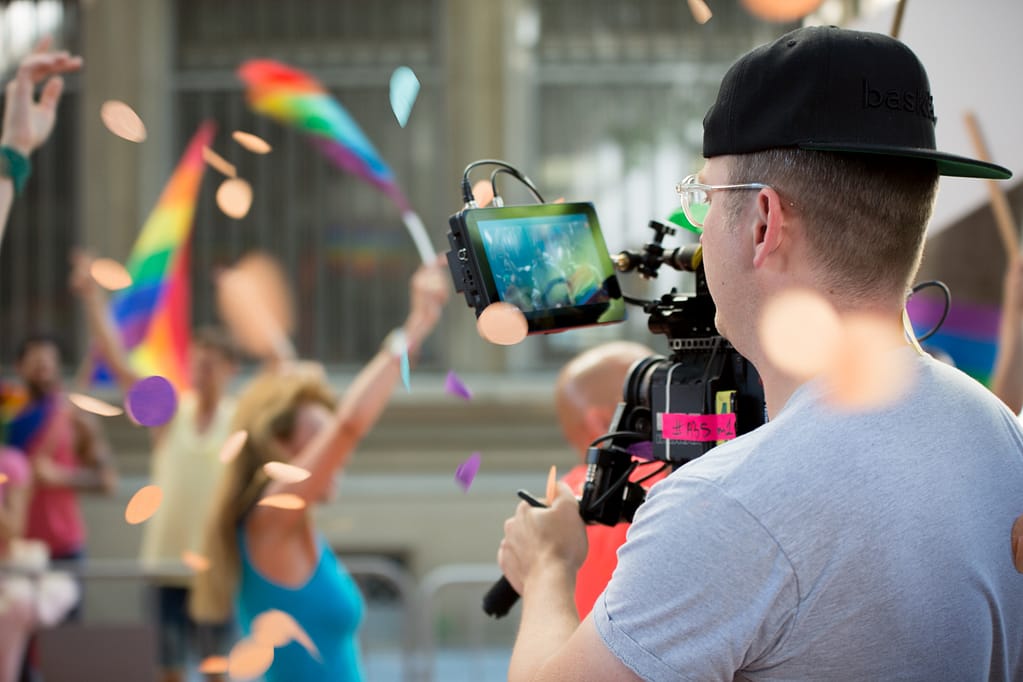Video camera operator filming LGBT Pride Festival in Barcelona