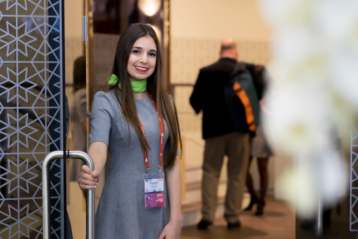 Girl smiling and holding the door