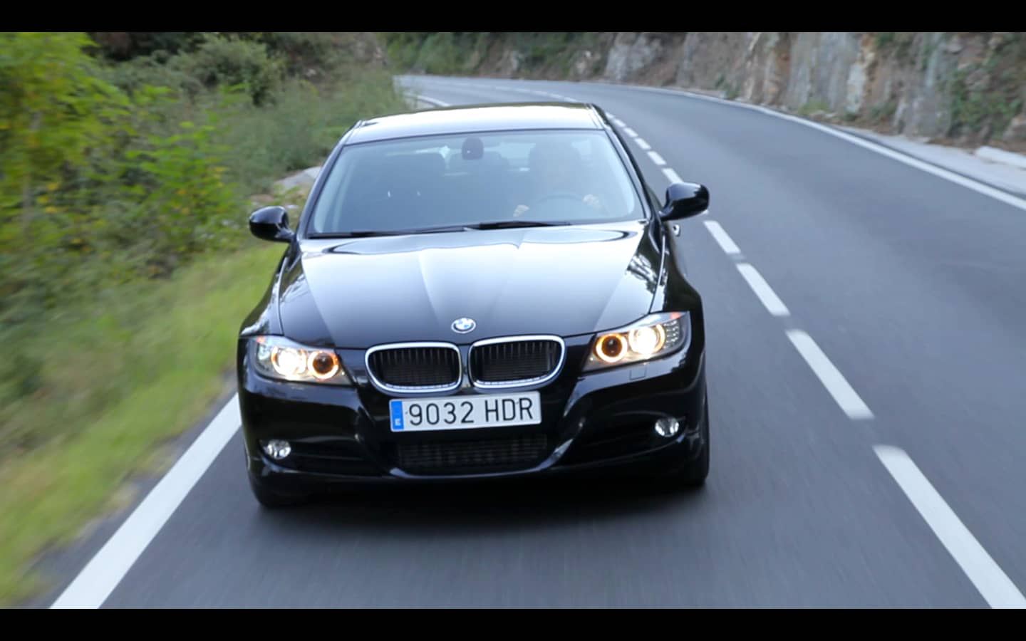 black car on the road close front view screenshot from a corporative advertisement video