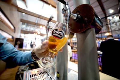 Bartender is taping a Estrella Galicia beer at a food fair