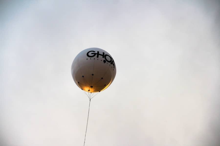 a white balloon with a logo in the air